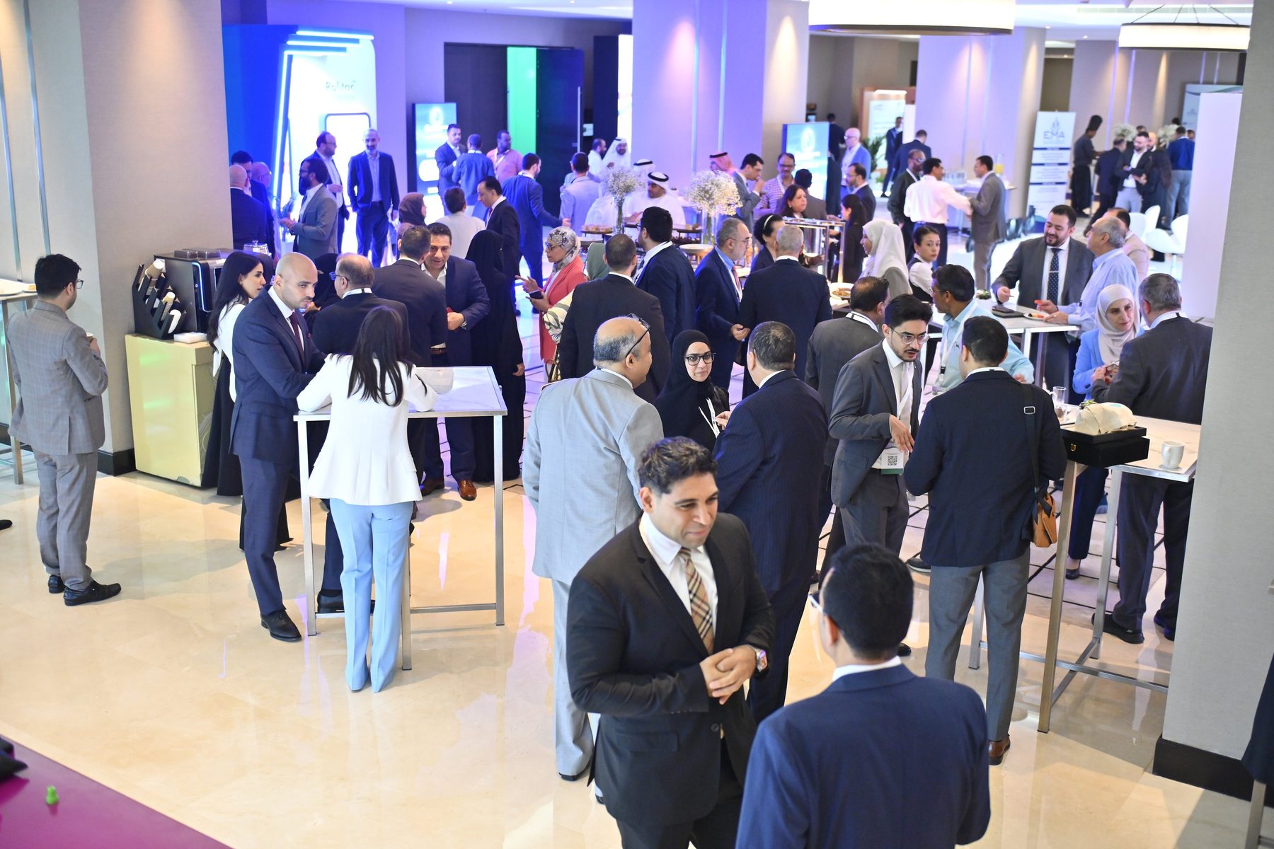 Delegates networking in the conference foyer between Pixanova LED screens